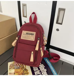Red canvas casual chest backpack with multi-pockets, stylish daily travel bag for men and women.