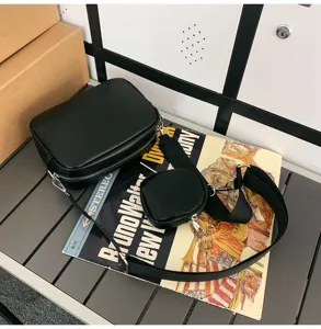 Gedetailleerd overzicht van de zwarte lederen crossbody tas met afneembaar mini tasje en ritsen.