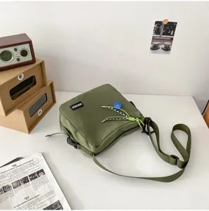 Japanese style solid color canvas crossbody bag casual messenger bag for daily use and travel.