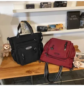 Canvas tote bag large capacity shoulder bag multi-pocket student casual handbag with cute pendant.