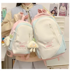 Japanese style large capacity dopamine school backpack detail view with cute plush pendants.