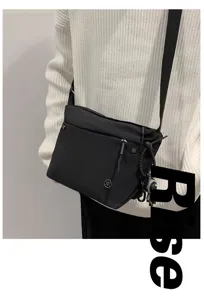 Black nylon crossbody bag for women lightweight waterproof casual shoulder bag daily travel.