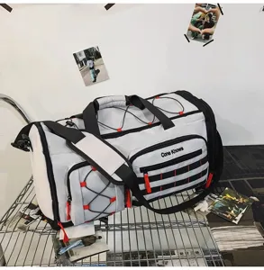 Detail view of large capacity multi-functional travel duffel bag with black straps and red accents.