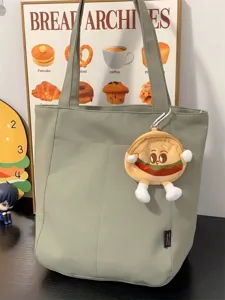 Detailed view of the Japanese ins-style casual canvas tote bag with cute plush burger charm.