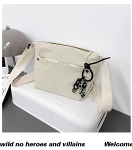 Casual canvas crossbody bag for women, lightweight nylon daily shoulder bag with cute pendant.