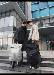Detailed streetwear style shot showing the large capacity backpack in an outdoor setting.