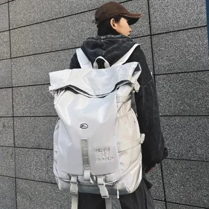 Detail view of large capacity silver grey backpack with multiple straps and motivational text.