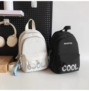 Closeup view of casual mini backpacks in black and white, featuring front pocket and cool print.