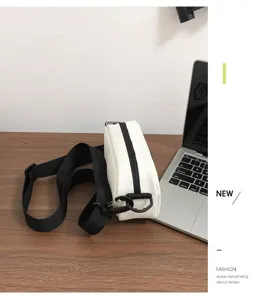 Detail view of a minimalist white waterproof crossbody bag with black strap for daily use.