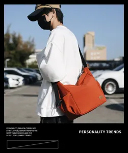 Canvas messenger bag detail showing spacious interior, durable strap and practical side pockets.