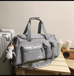 Graue Sport- und Reisetasche im Detail, mit mehreren Taschen und langlebigem Material.