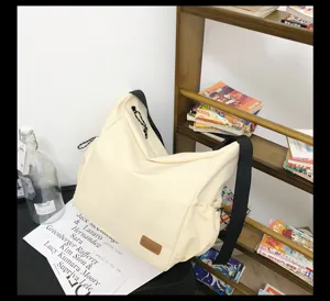 Canvas messenger bag detail view, casual large capacity shoulder bag for daily travel use.