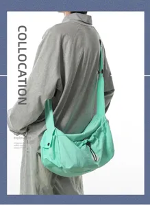 Detail view of the lightweight green casual messenger bag, showing strap and drawstring structure.
