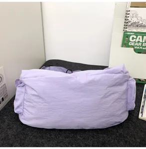 Detail view of the lightweight purple travel bag on a dark surface, showing large capacity.