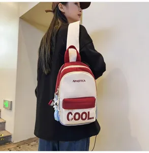 Detail view of trendy contrast color chest backpack with letter print for casual daily travel.