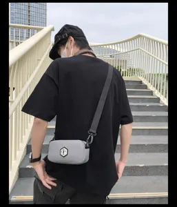 Detail shot of a lightweight waterproof crossbody phone bag worn outdoors, versatile style.