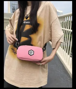 Pink waterproof crossbody phone bag for women and men, stylish portable small messenger bag detail view.