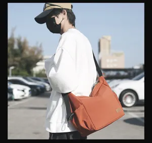 Detail shot of the casual canvas messenger bag showing the wide strap and large capacity design.