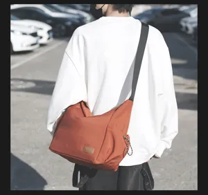 Large capacity canvas crossbody bag for daily travel, casual messenger bag with wide strap.