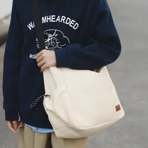 Large capacity canvas crossbody bag lightweight casual messenger bag for daily travel.