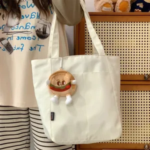 Casual canvas tote bag for women with cute burger charm, large capacity student commuter bag.