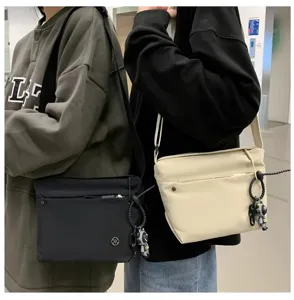 Casual nylon crossbody bag for women, lightweight waterproof shoulder bag with charm.