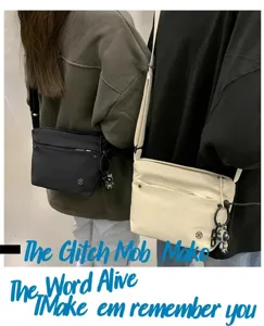 Detail view of the casual nylon crossbody bag, showing double strap and front zipper pocket.