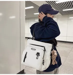 Large capacity white canvas tote bag with shoulder strap, ideal for daily student use.