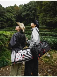Outdoor detail view of multi-functional travel duffel bag and fitness backpack in a scenic garden.