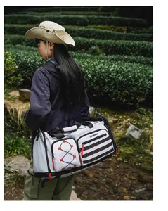 Large capacity outdoor travel duffel bag with multi-functional pockets and stylish grey design.