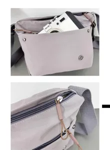 Casual nylon crossbody bag detail shot showing front pocket and zipper design.