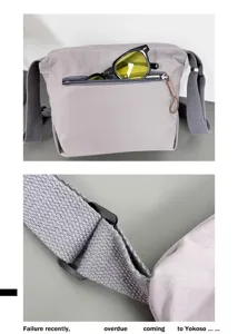 Detail view of grey nylon crossbody bag showing zipper pocket and strap buckle.