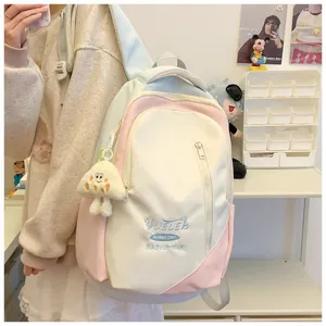 Japanese style large capacity dopamine backpack for women and students with cute pendant.