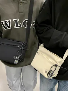 Casual nylon crossbody bag for women, lightweight stylish shoulder bag with cute spaceman pendant.