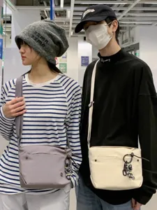 Casual canvas crossbody bag for women, lightweight nylon shoulder bag with cute keychain.