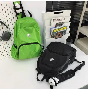 Detail view of lightweight waterproof outdoor casual backpack with cute panda charm and roomy storage.