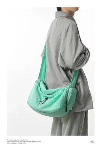 Light green casual crossbody bag with drawstring design and spacious compartment for daily use.