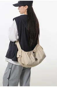 Casual nylon crossbody bag with drawstring design, large capacity for daily outdoor travel and sport.