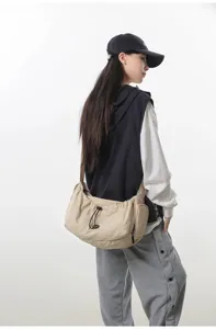 Casual canvas crossbody bag with drawstring design for women, large capacity daily use.