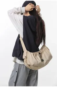 Lightweight casual nylon crossbody bag with spacious storage and adjustable drawstring design.