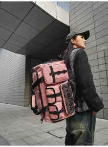 Detailed view of large capacity pink multi-functional travel backpack worn outdoors.
