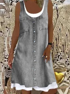 Close-up of gray denim sleeveless button-down fake two-piece dress with dual pockets.