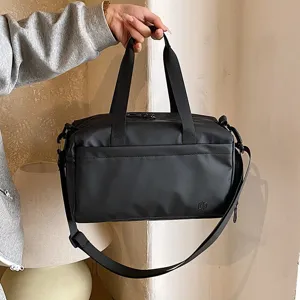 Black travel gym duffle bag with shoulder strap, waterproof sports fitness bag for men and women.