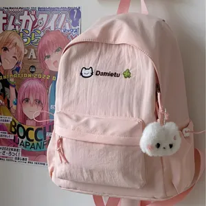 Cute pink casual backpack for women and students with embroidered cat logo and plush charm detail.