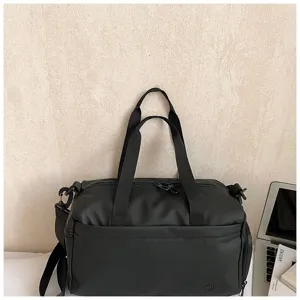 Detailed view of black waterproof gym duffel bag, compact travel luggage with durable straps.