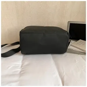 Detail shot of black waterproof fitness duffel bag, showing smooth zipper and durable strap.