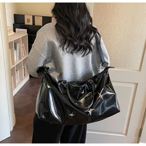 Large capacity black glossy travel duffel bag for women, perfect for gym and short trips.