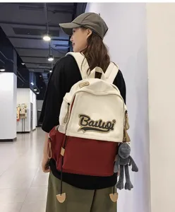 Stylish two-tone canvas backpack for women, large capacity school bag for daily travel use.