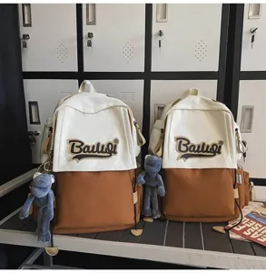 Detailed view of the stylish color-block backpack with cute frog pendant for students and travel.