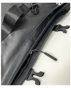 Detailed view of black waterproof backpack with durable zippers, straps, and buckles.